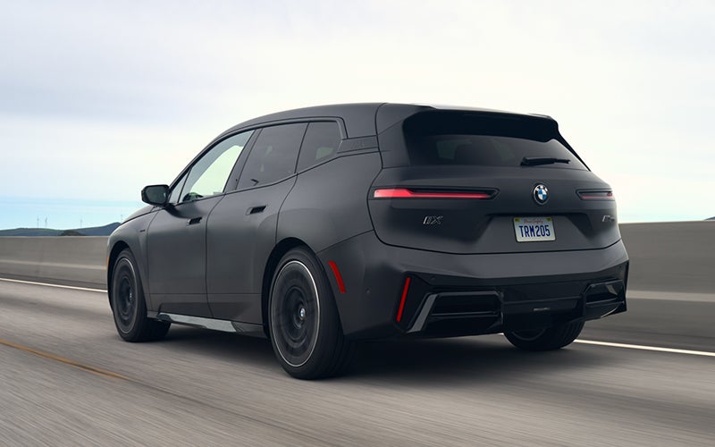 The BMW iX M70 driving rear shot. | BMW of Westbrook in Westbrook ME