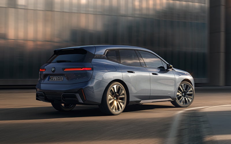 The BMW iX driving with the front wheel turned. | BMW of Westbrook in Westbrook ME