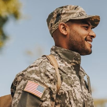 A smiling man dressed in a military uniform
