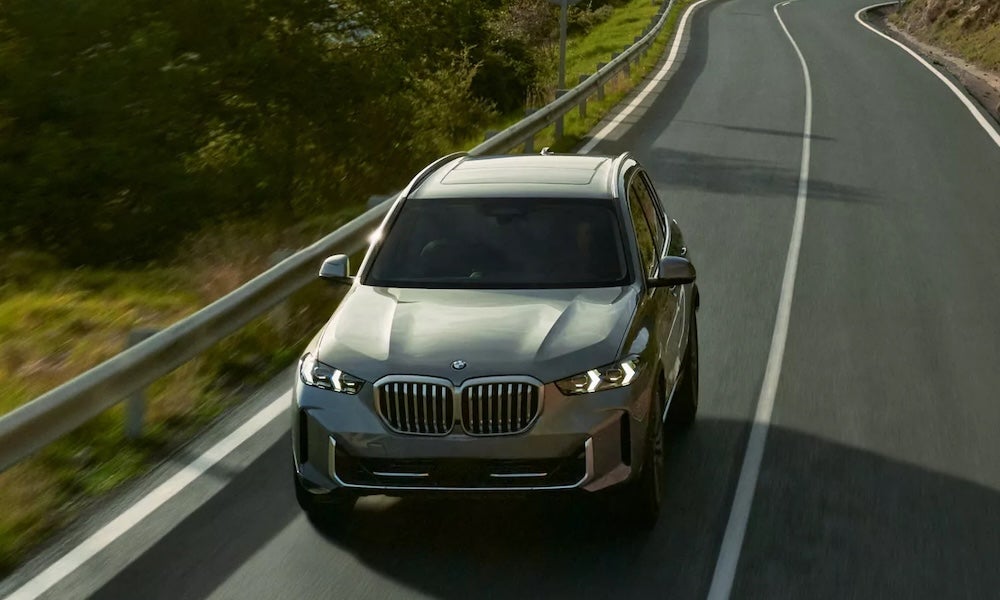 A gray BMW X5 SUV on a winding road